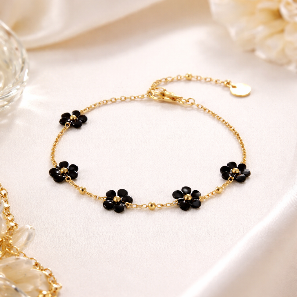 Gold bracelet with black flower shaped beads 