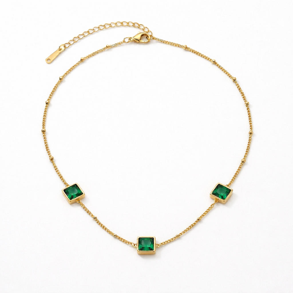 gold satellite chain necklace with three square emerald green stones