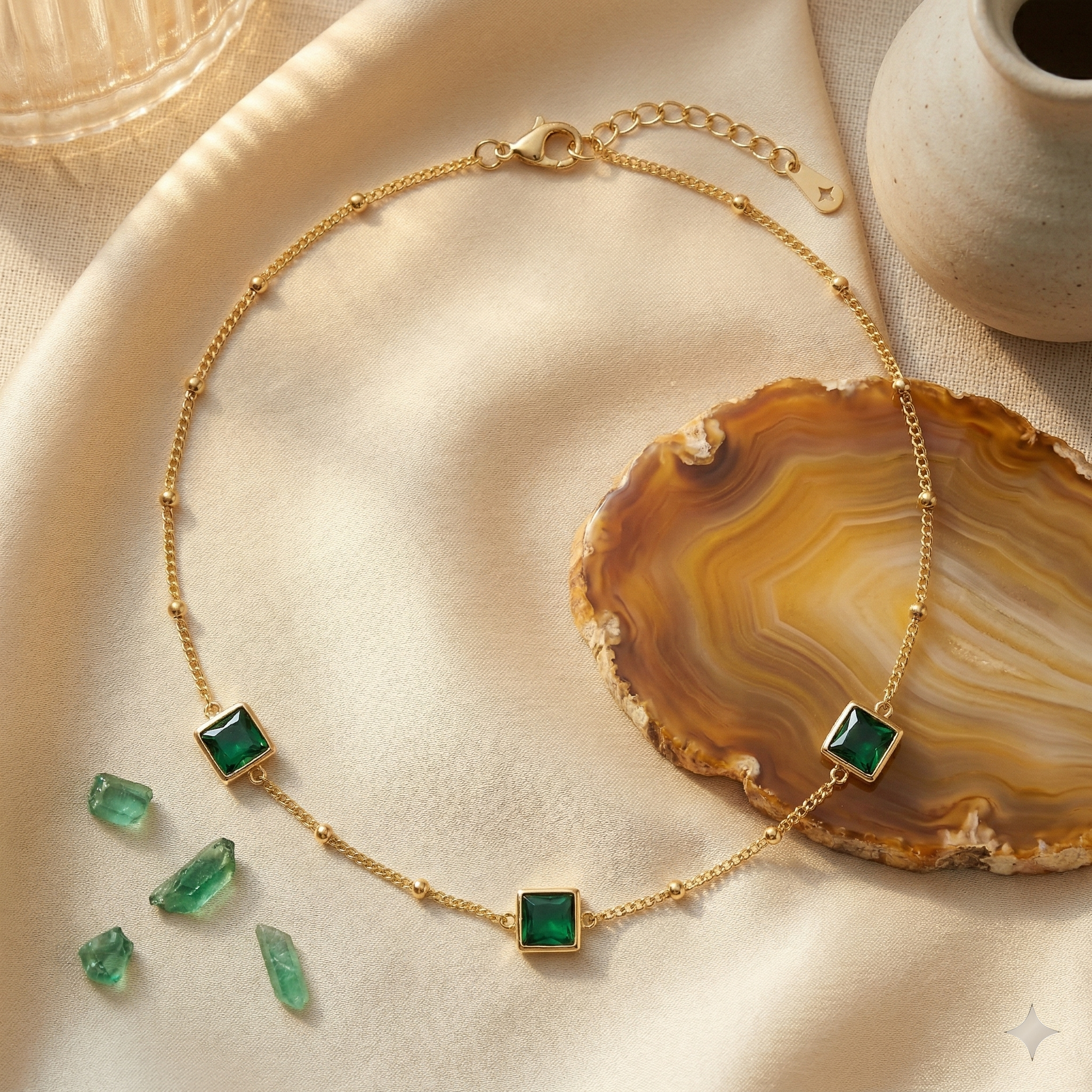 Shop our gold plated emerald green necklace. Features a dainty satellite chain and square-cut crystals. Perfect for layering. Tarnish-resistant and hypoallergenic.