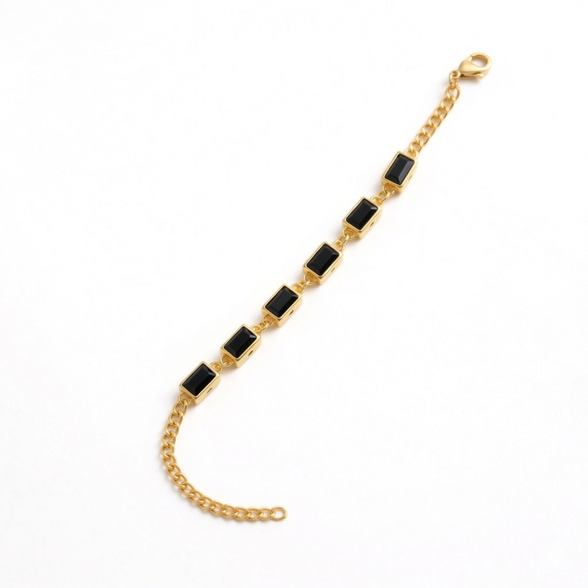 gold link bracelet featuring black baguette-cut stones on a white background
