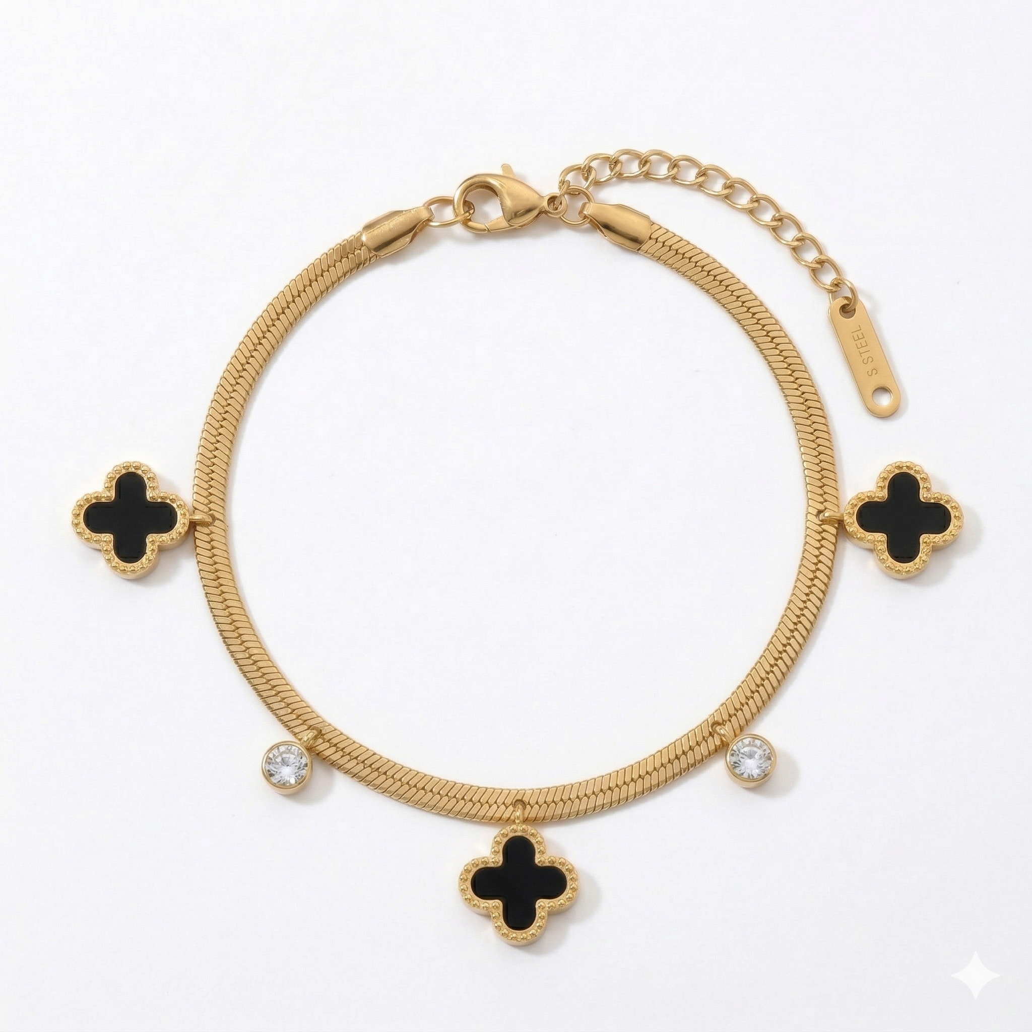 Gold snake chain bracelet with black clover charms and round bezel-set crystals